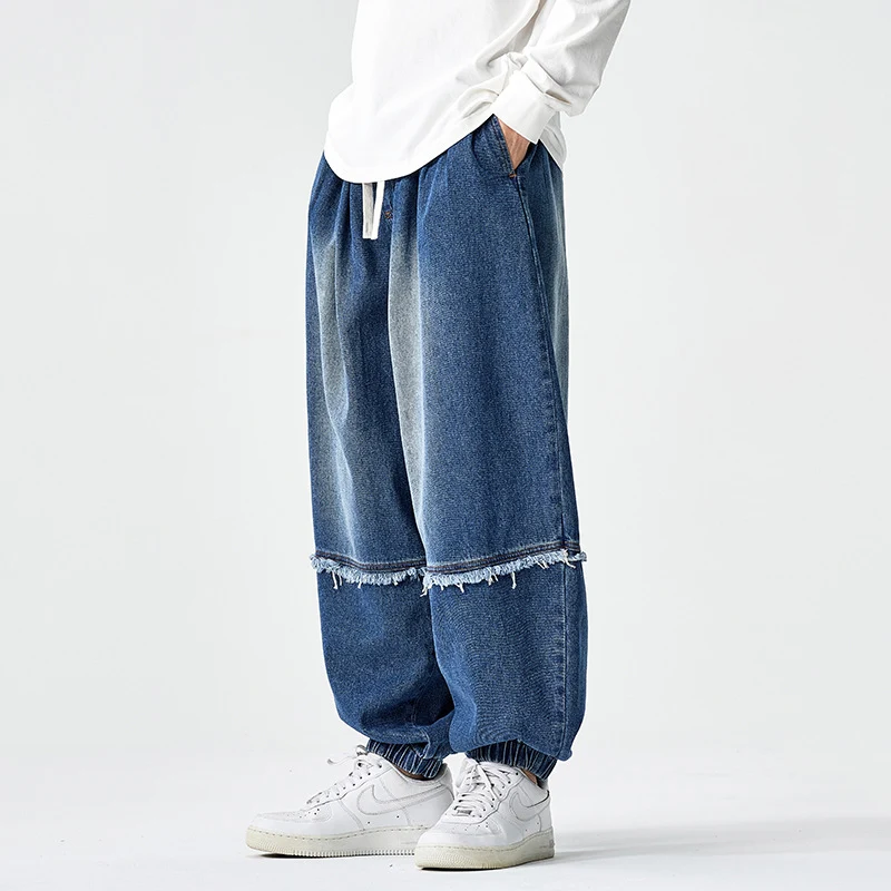 Herren Weit geschnittene Baggy-Denim-Hose mit Tunnelzug, elastischen Beinabschlüssen und Fransen-Detail Drune