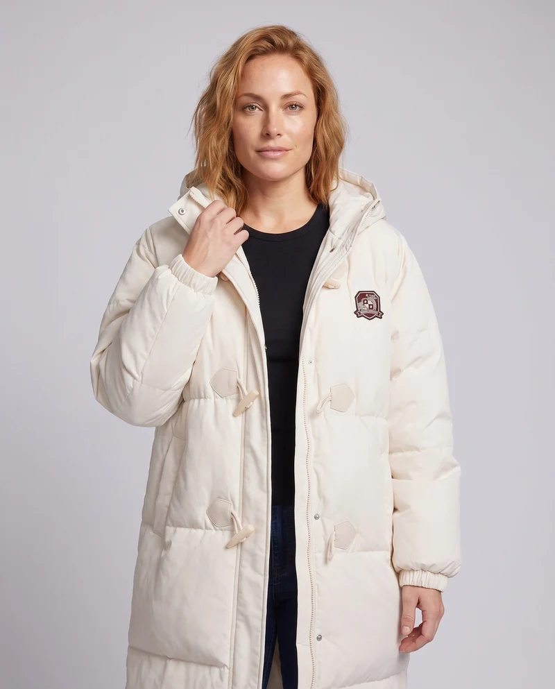 Damen langgeschnittene thermische Pufferjacke mit minimalistischer Knopfleiste, ergonomischem Stehkragen und geräumigen Seitentaschen