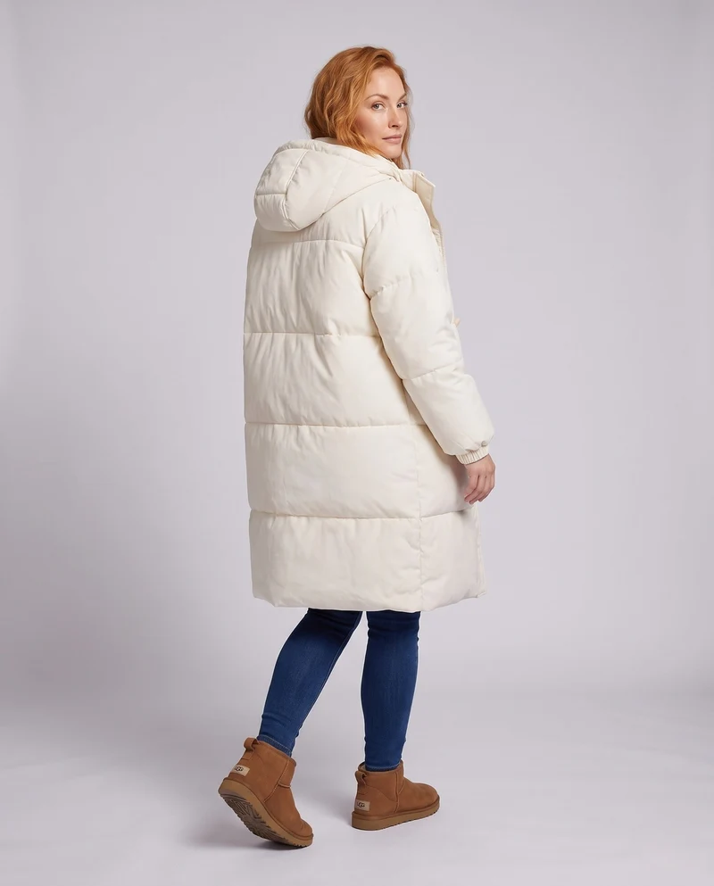 Damen langgeschnittene thermische Pufferjacke mit minimalistischer Knopfleiste, ergonomischem Stehkragen und geräumigen Seitentaschen