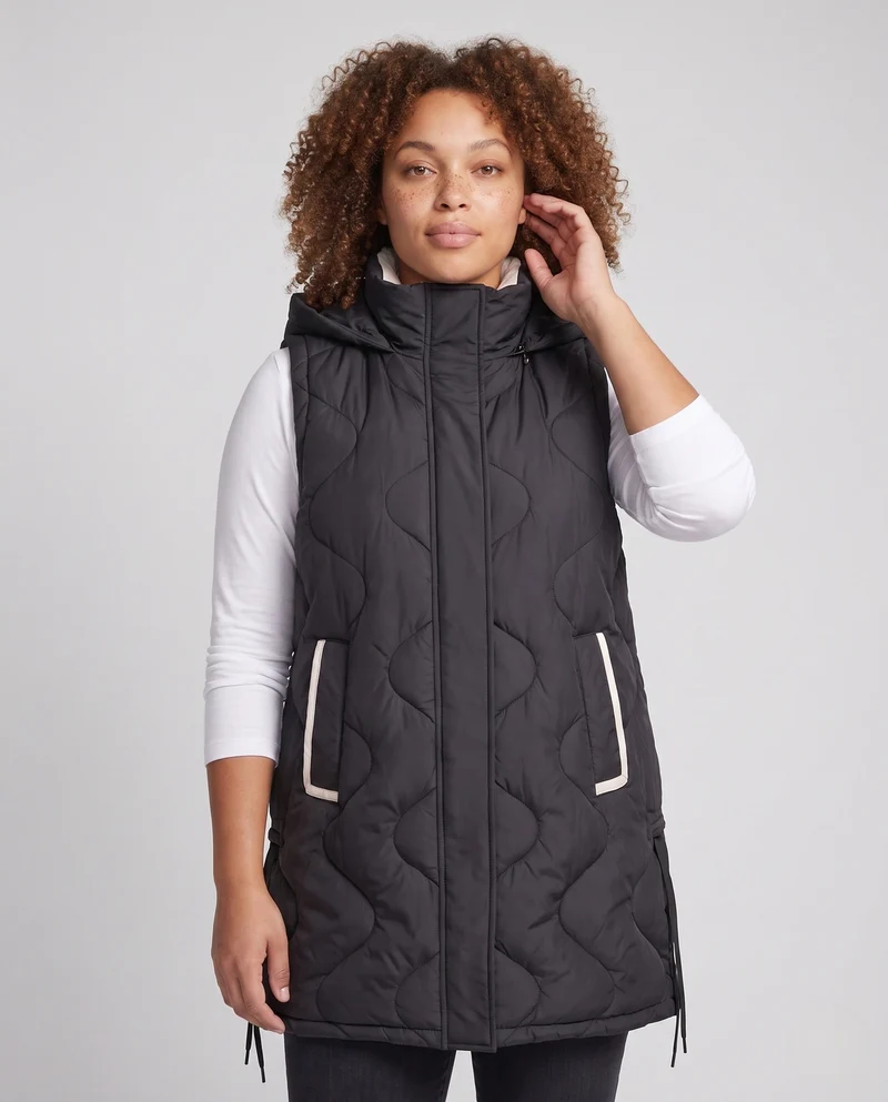Damen leichte gepolsterte lange Weste mit ergonomischer Wellensteppung, integrierter Kapuze und verstellbarem Saum
